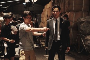 Director/Screenwriter directing Jung-jae Lee while filming 'New World'
